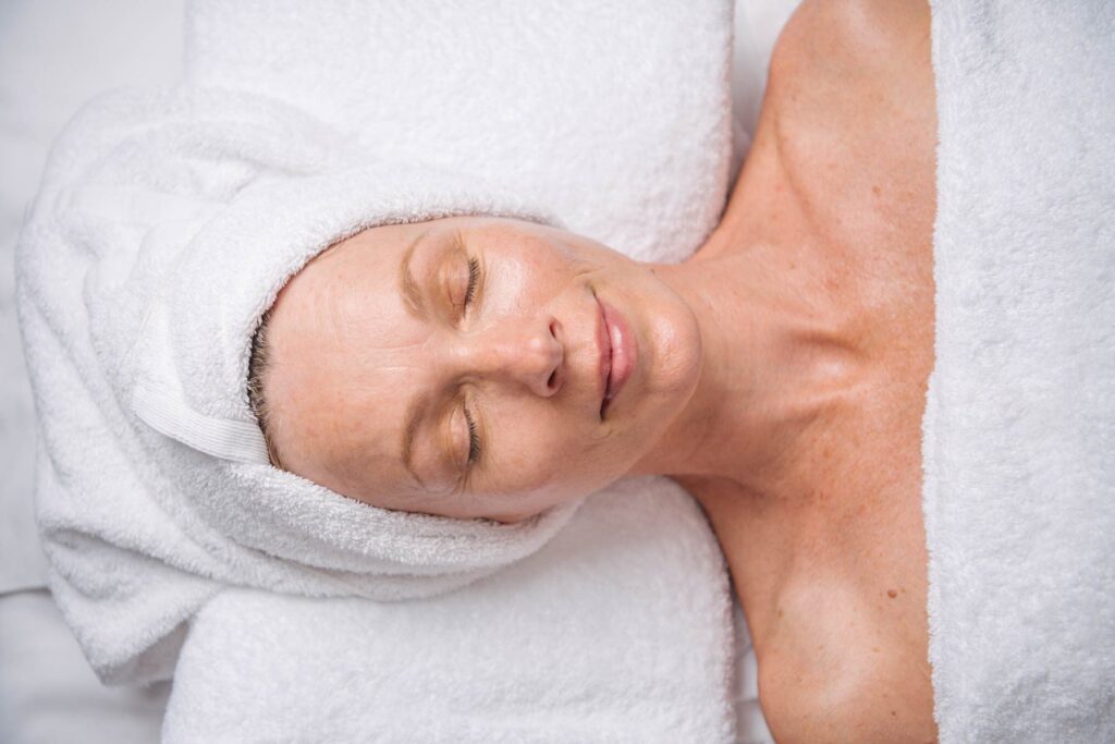 A relaxed woman receiving a spa treatment at Sol Spa.