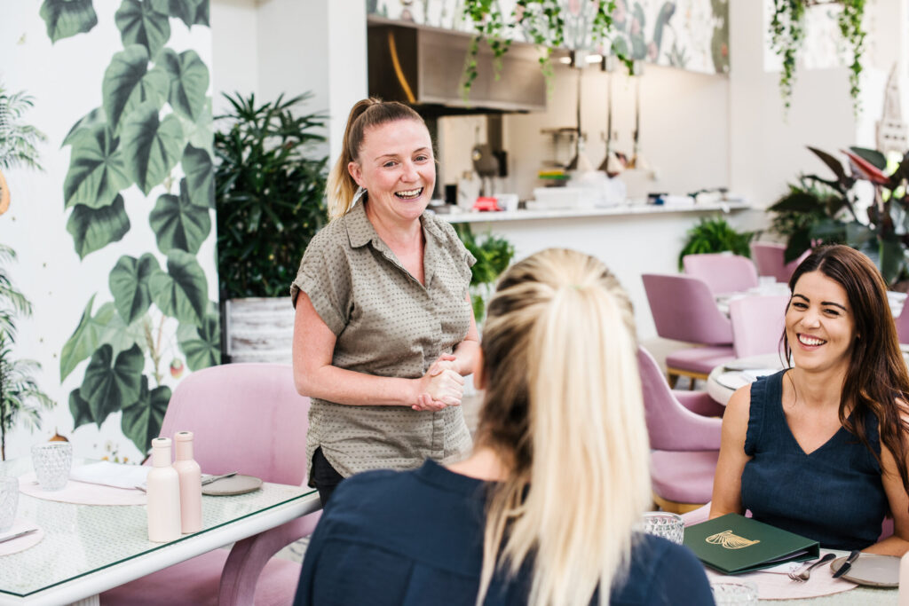 A woman laughing while talking