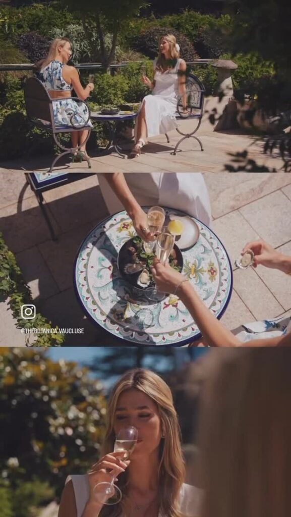 A three-panel collage shows two women enjoying drinks and fresh oysters on a sunny outdoor patio. The top panel shows them chatting at a table, the middle panel is a top-down view of them raising a champagne toast over a platter of oysters, and the bottom panel shows a close-up of one woman sipping her drink.